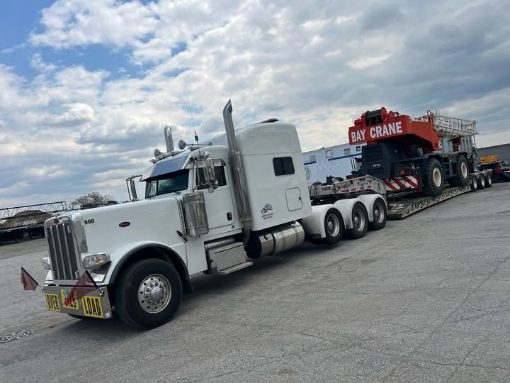 AJC Heavy Hauling Peterbilt hauling a Bay Crane on a lowboy trailer